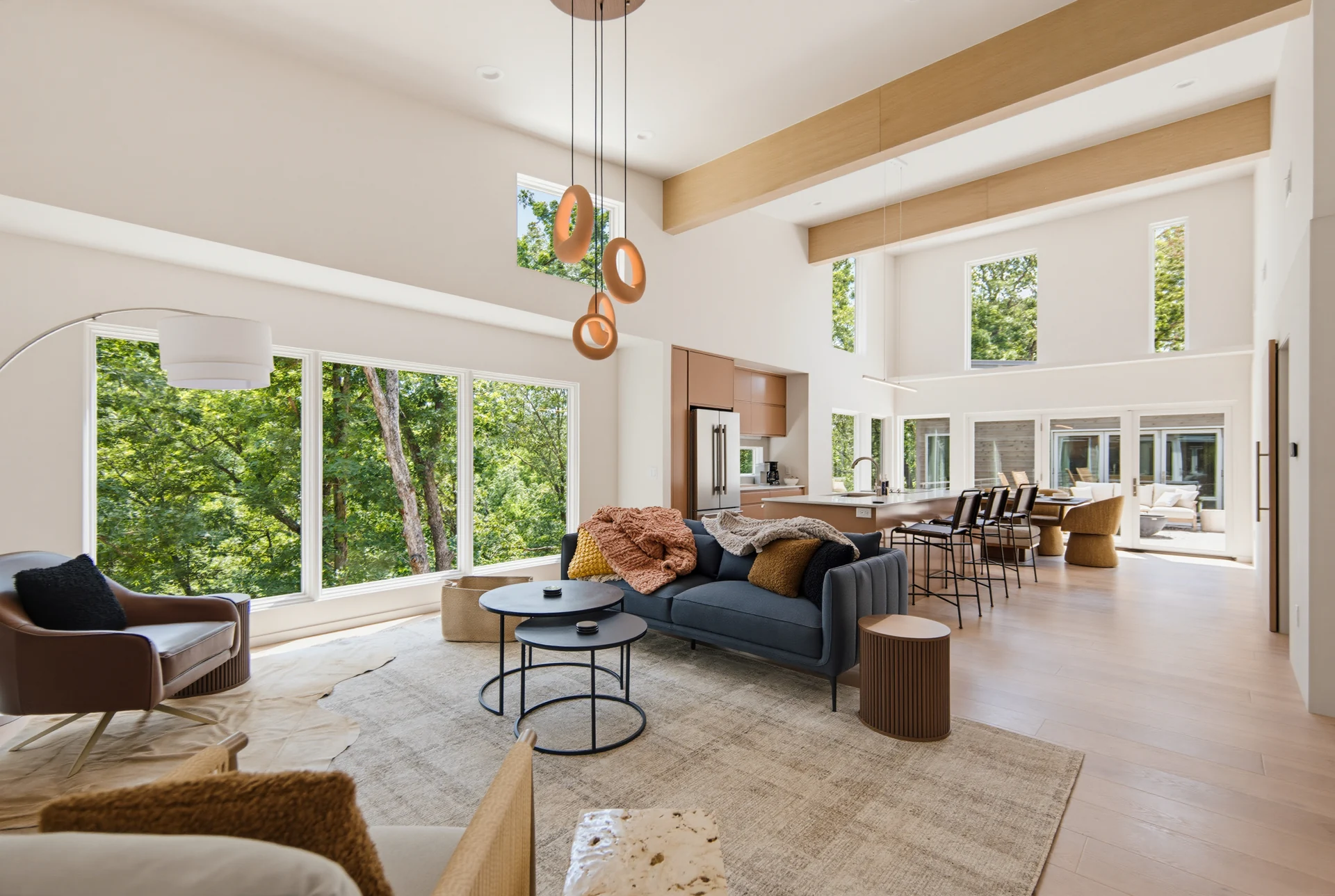 Bella Vista living room with tall windows overlooking trees