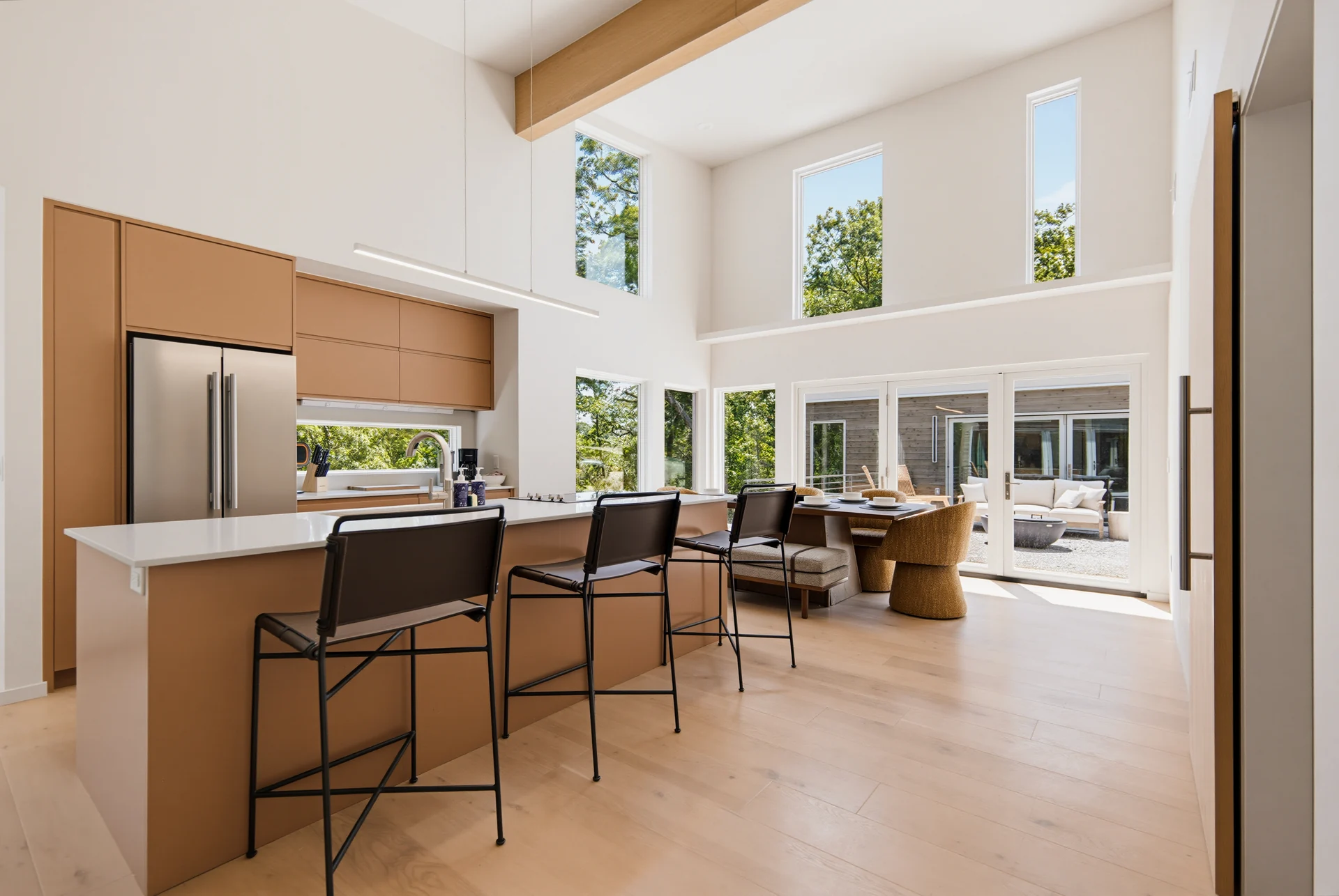 Light wood kitchen cabinetry opening to the living space