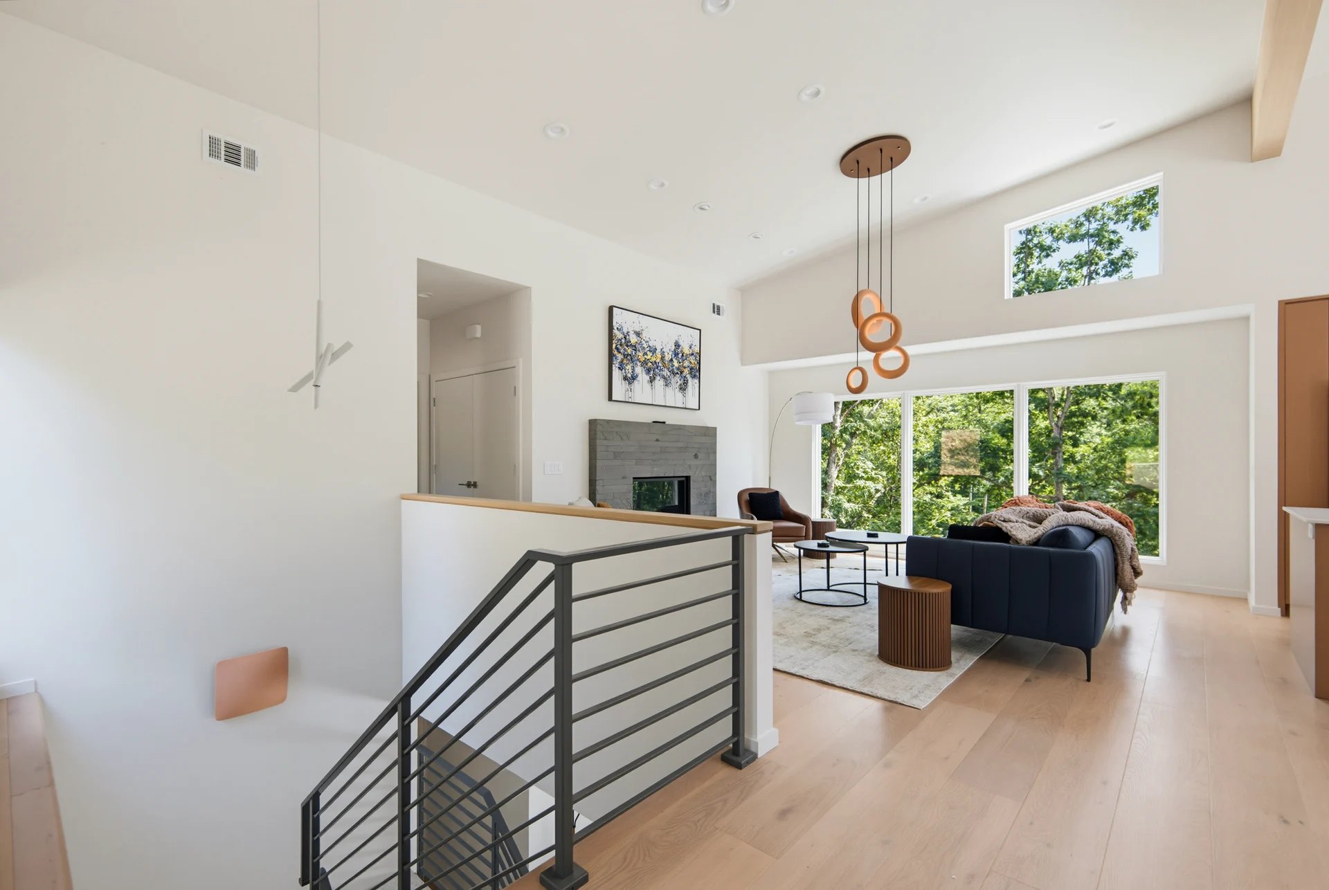 Dark metal stair railing beside the open living area