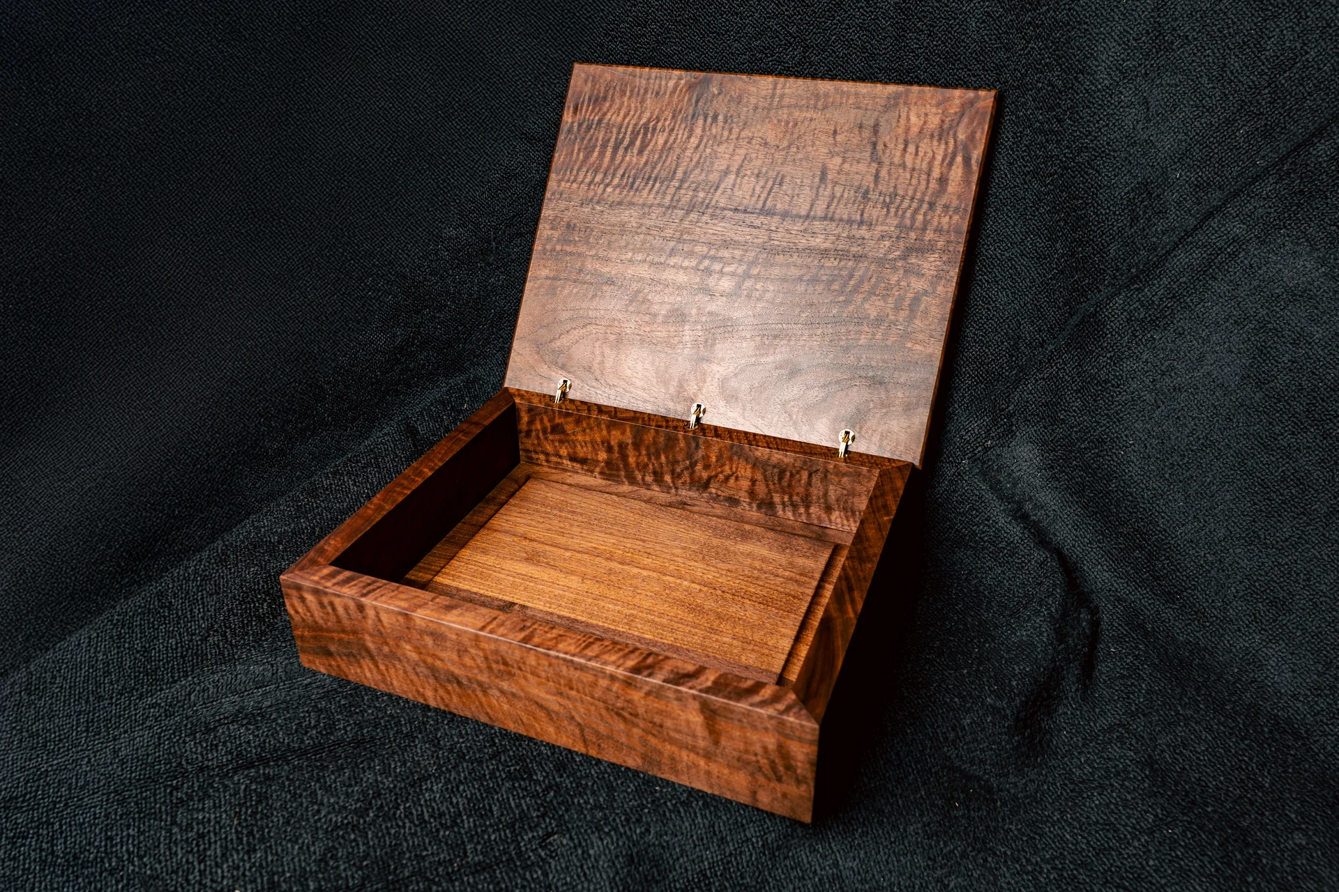 Open box showing its finished wood interior