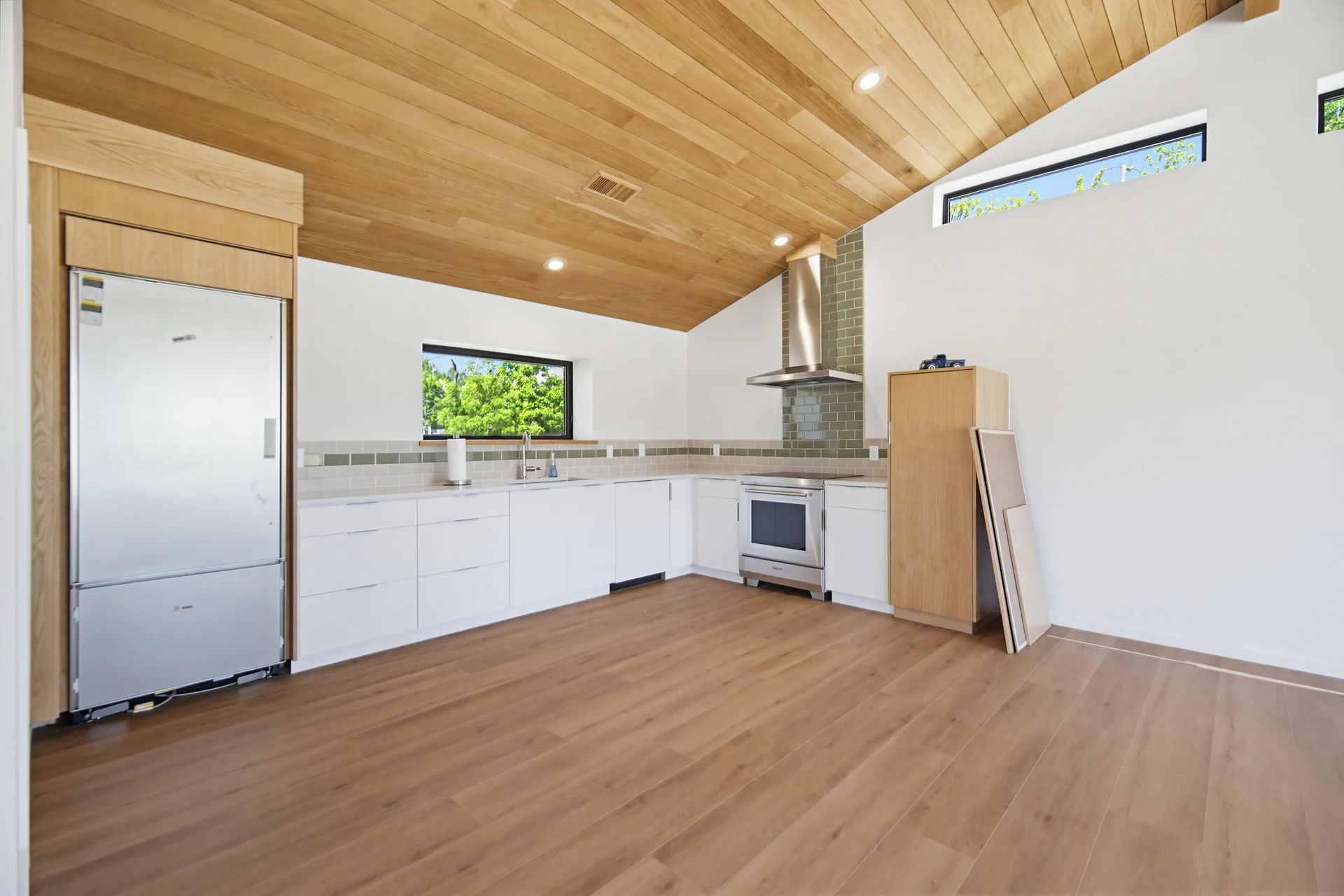 White kitchen beneath the sloping wood ceiling