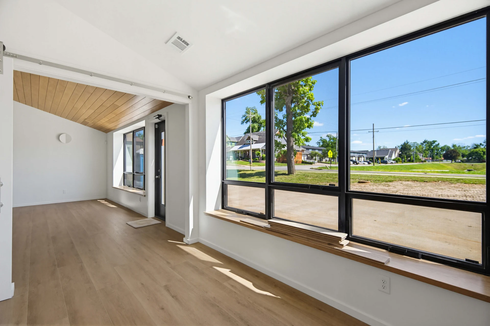 Large living-room windows overlooking the front lawn