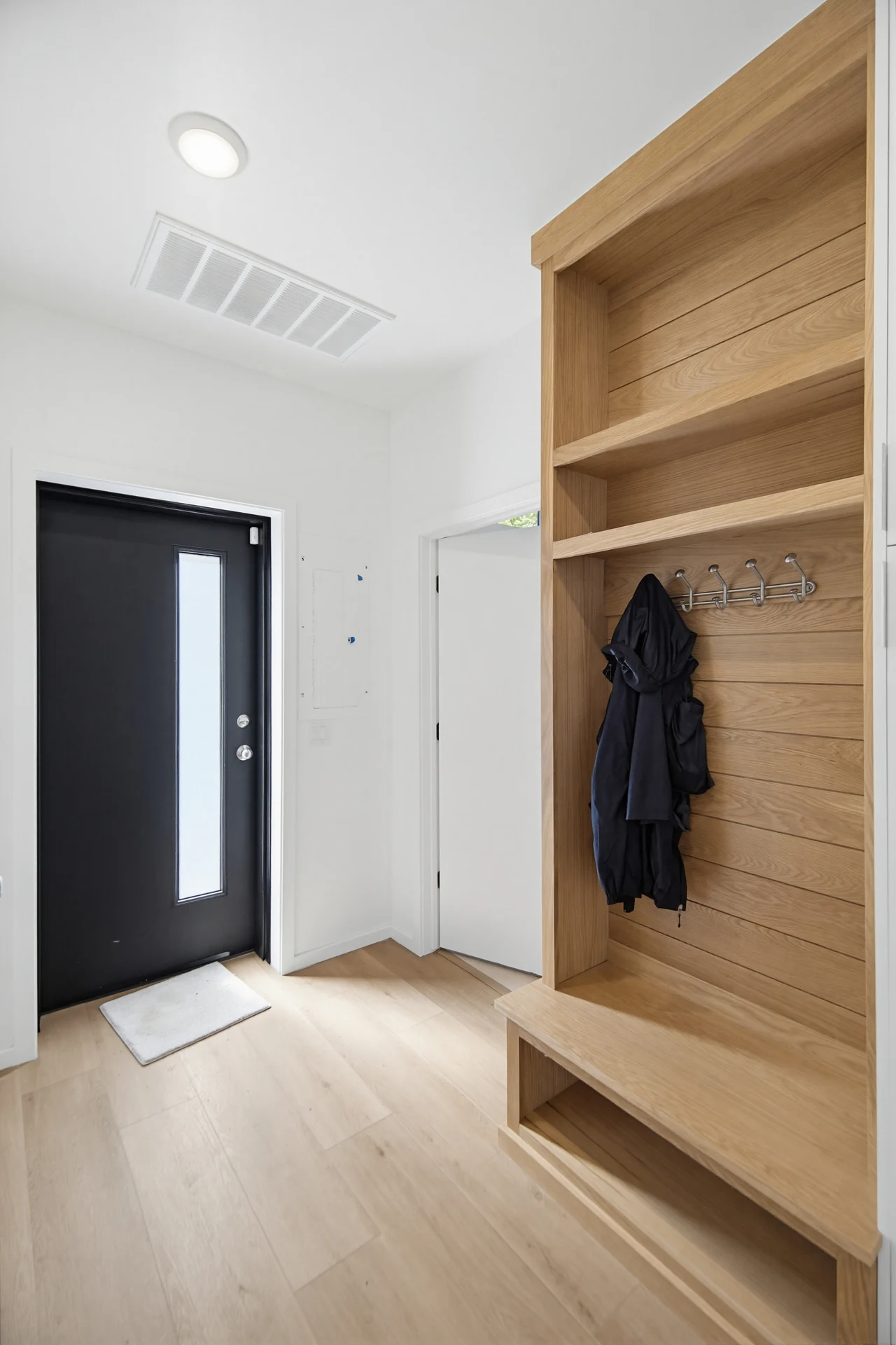 Wood entry storage with a built-in bench and hooks