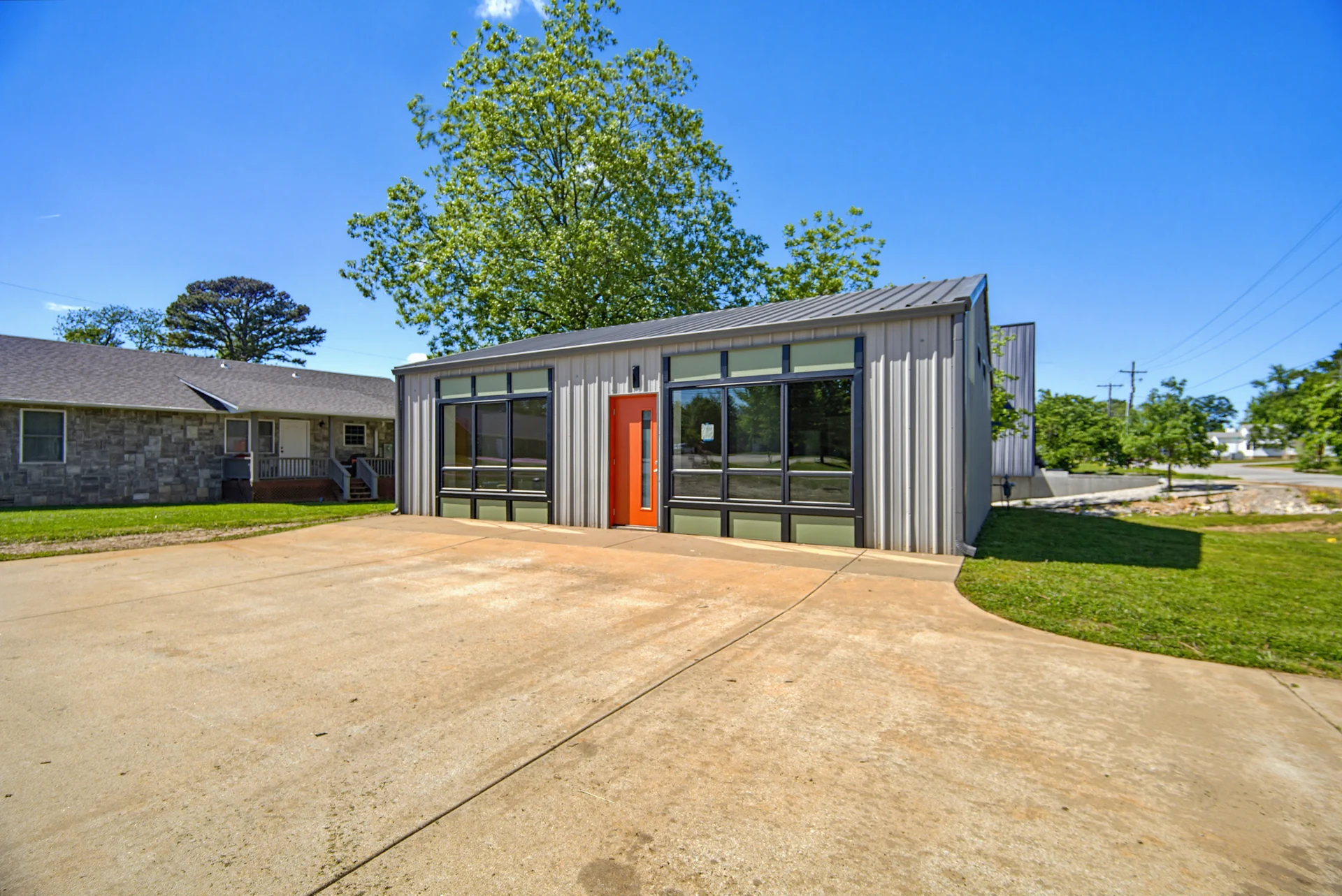Exterior view across the driveway toward the glazed front wall