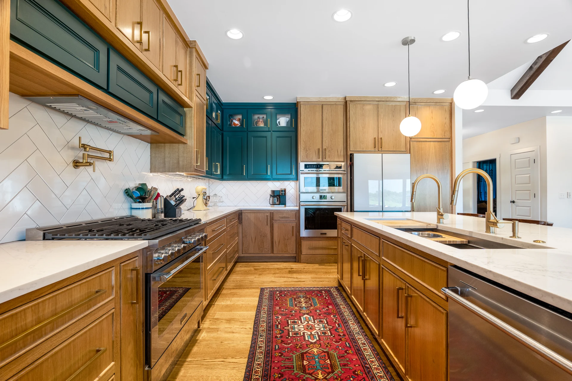 Kitchen cabinetry, tiled backsplash, and brass-toned fixtures