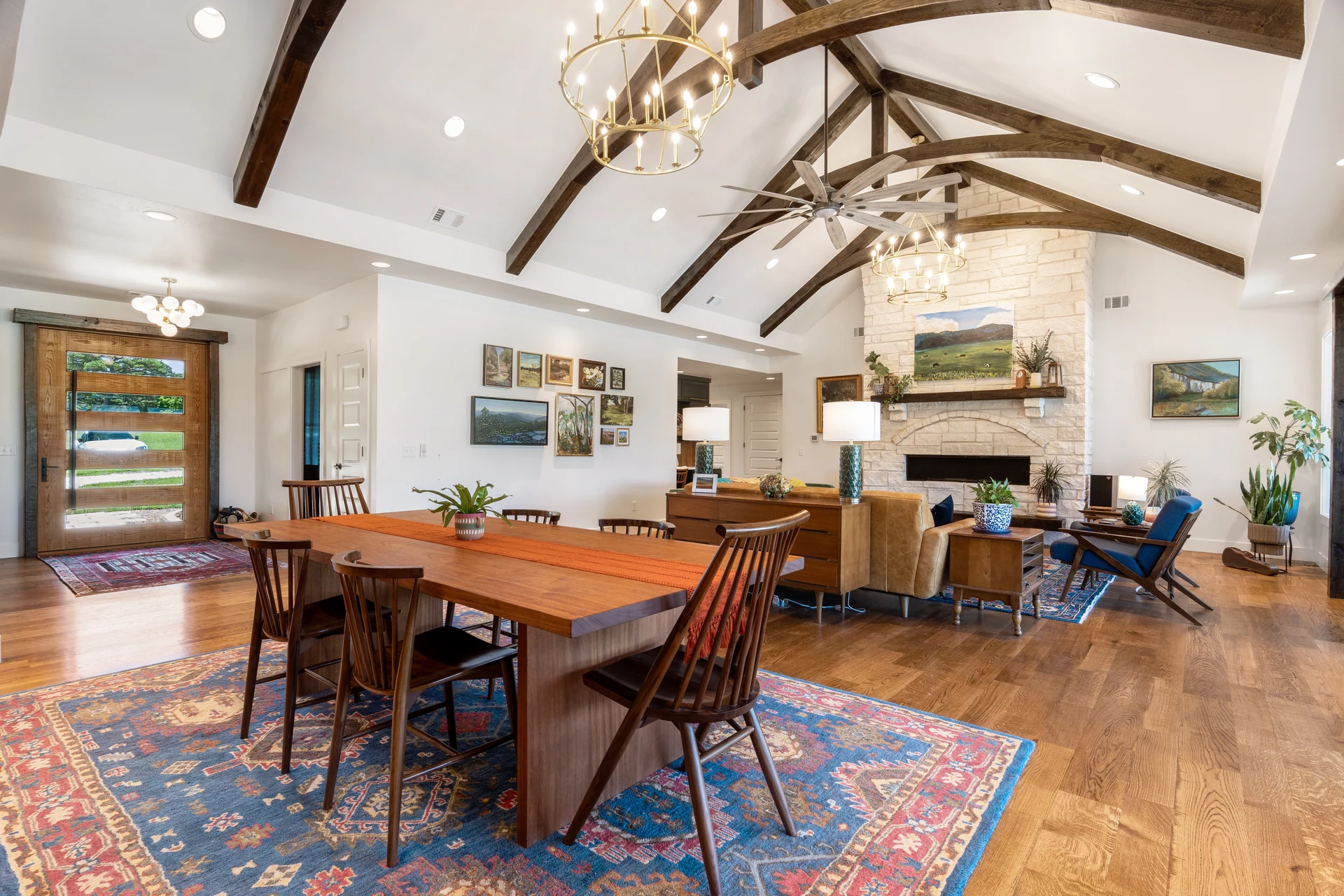 Open dining and living space beneath exposed timber trusses