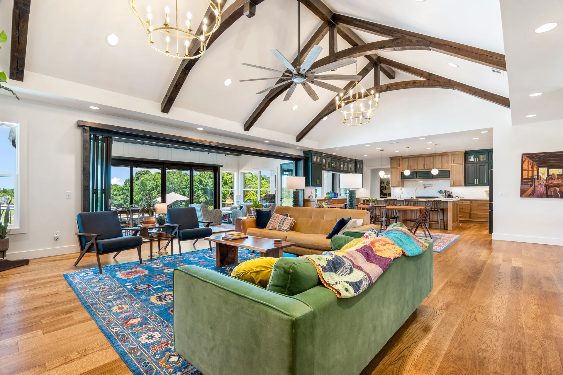 Living room with large windows and a stone fireplace