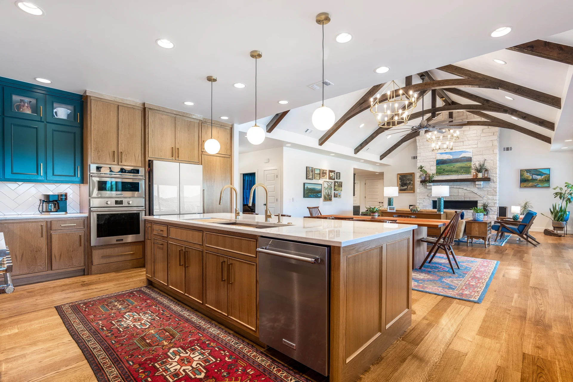 Kitchen island opening toward the timber-truss living space