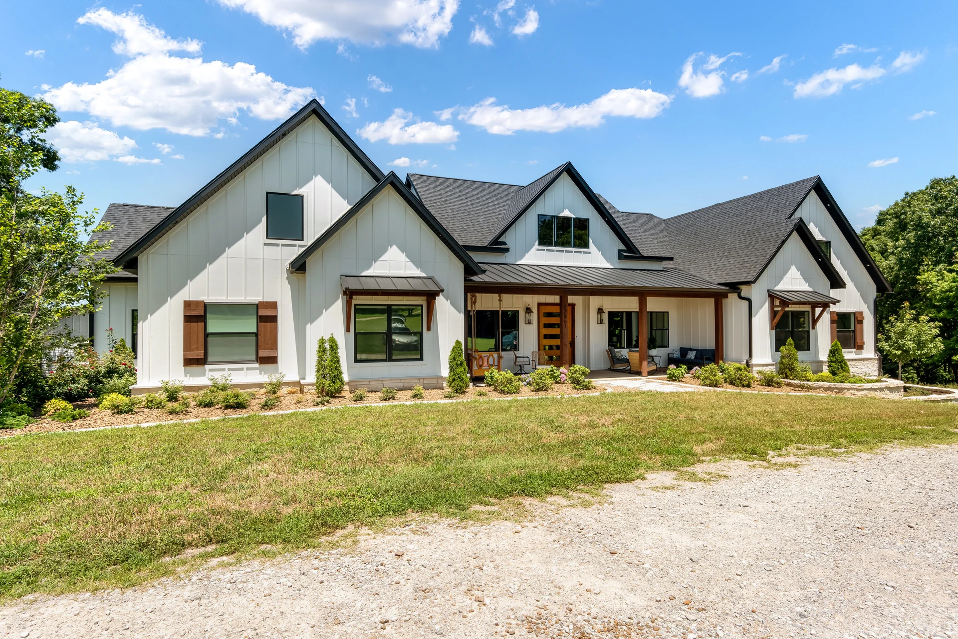 Angled view of the home’s gabled roofline and front porch